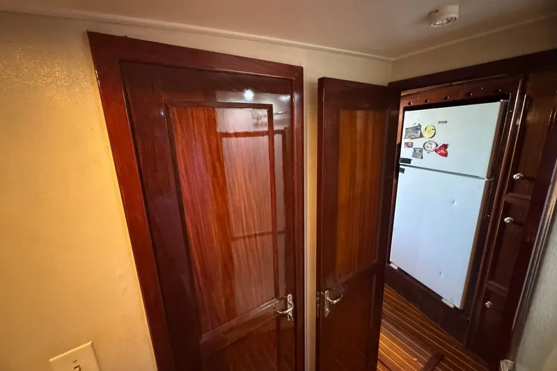 Slide: The Image of Interior of 1981 Hatteras 43 Convertible with wooden doors and a refrigerator. - 40