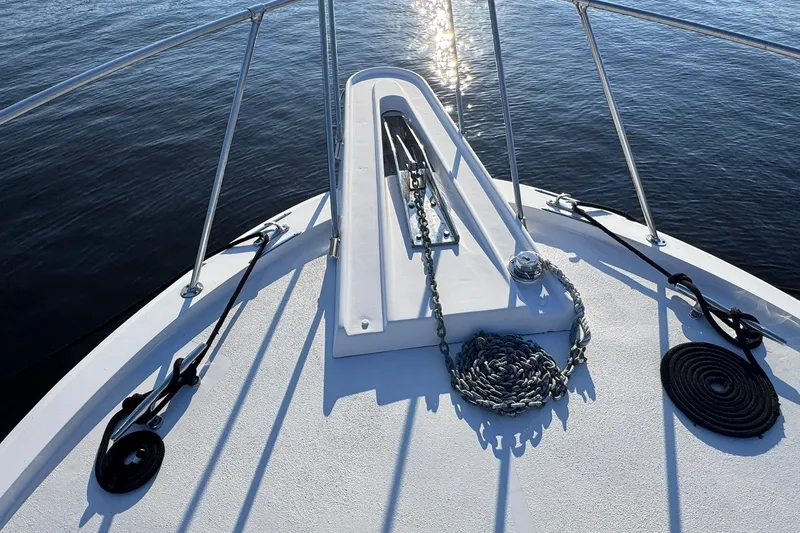 Slide: The Image of Bow of 1981 Hatteras 43 Convertible yacht with anchor chain and calm water. - 66