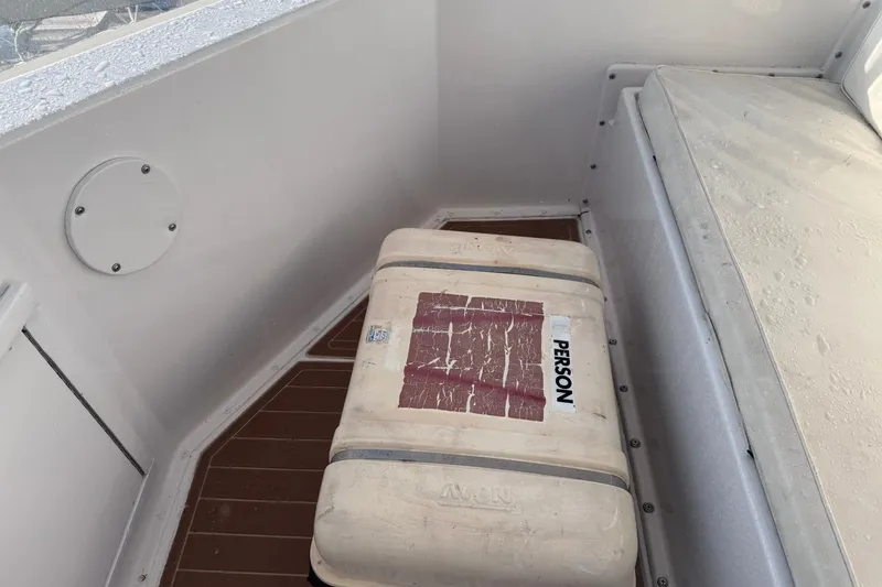 Slide: The Image of Interior of 1981 Hatteras 43 Convertible with a white storage box on wooden flooring. - 59