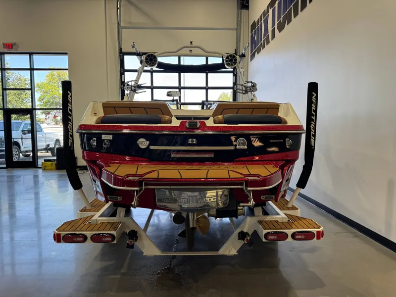 Slide: The Image of Rear view of a 2021 Malibu Wakesetter 23 LSV inside a showroom. - 6
