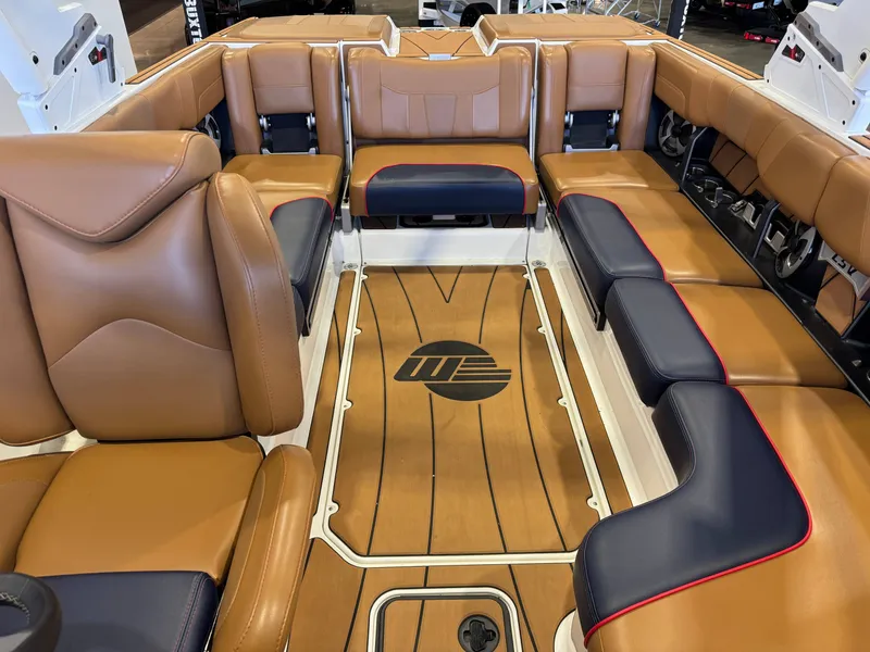 Slide: The Image of Interior of a 2021 Malibu Wakesetter 23 LSV with brown and blue leather seating. - 21