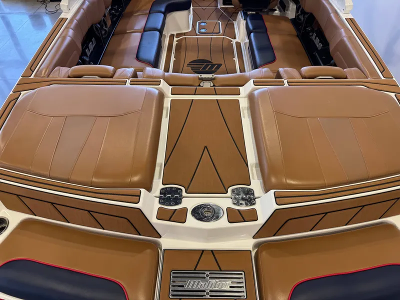 Slide: The Image of The image shows the cockpit of a 2021 Malibu Wakesetter 23 LSV with brown upholstery. - 9