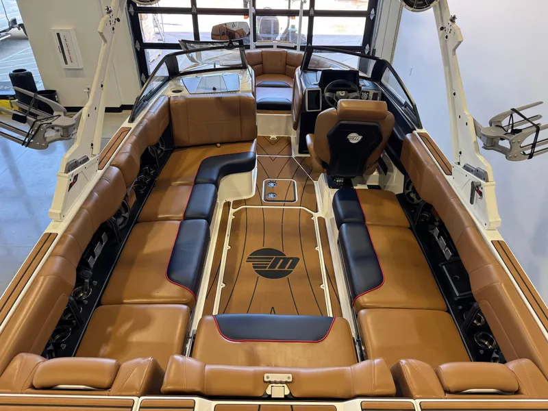 Slide: The Image of The image shows the interior of a 2021 Malibu Wakesetter 23 LSV with brown leather seating. - 12