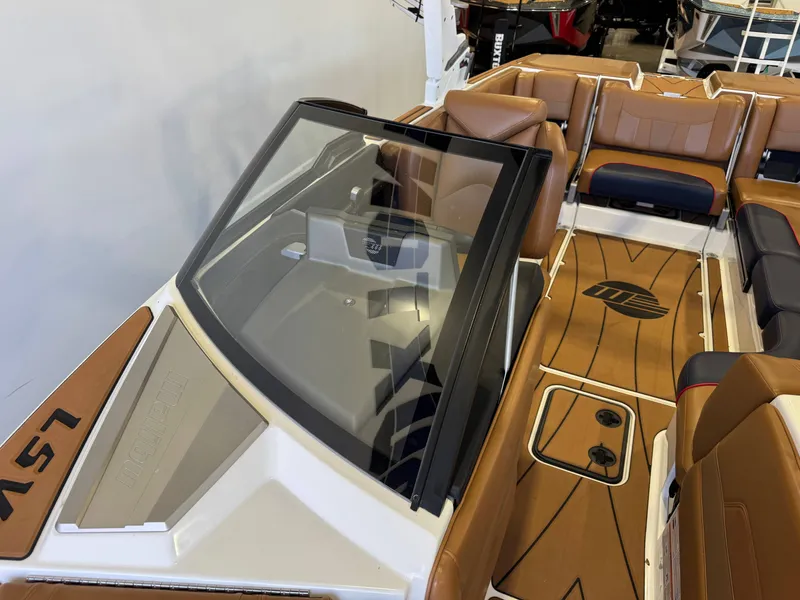 Slide: The Image of The image shows the cockpit of a 2021 Malibu Wakesetter 23 LSV with brown leather seats. - 19