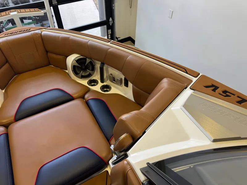 Slide: The Image of Interior of a 2021 Malibu Wakesetter 23 LSV with brown leather seats and speakers. - 17
