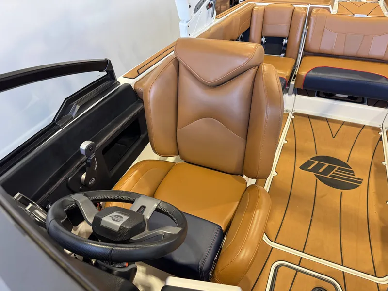 Slide: The Image of The image shows the interior of a 2021 Malibu Wakesetter 23 LSV with brown leather seats. - 20