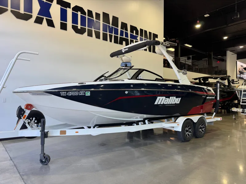 Slide: The Image of A 2021 Malibu Wakesetter 23 LSV on a trailer in a showroom. - 2