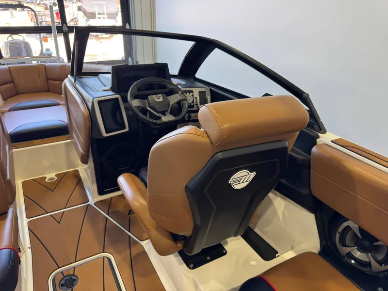 Slide: The Image of The image shows the cockpit of a 2021 Malibu Wakesetter 23 LSV with brown leather seats. - 23