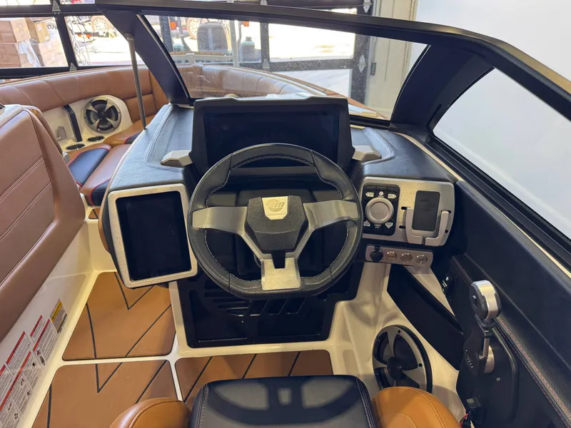 Slide: The Image of The image shows the cockpit of a 2021 Malibu Wakesetter 23 LSV with a modern steering wheel and instruments. - 25