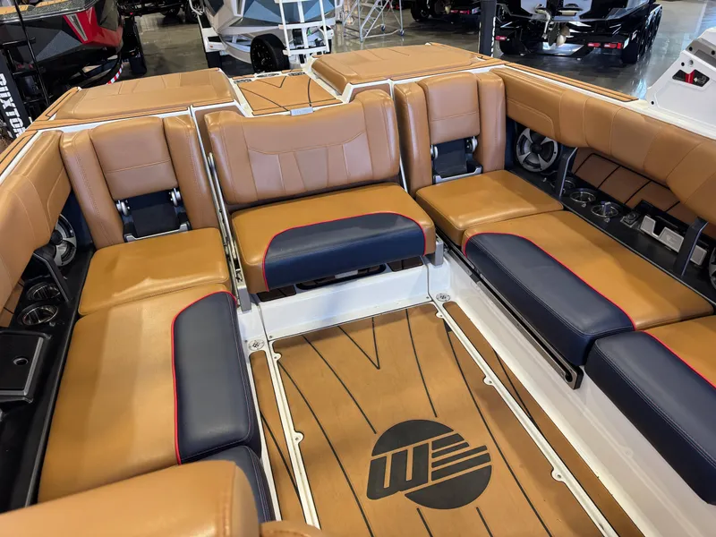 Slide: The Image of The image shows the interior of a 2021 Malibu Wakesetter 23 LSV with brown and blue seating. - 15