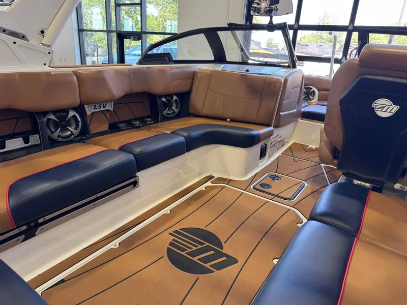 Slide: The Image of Interior of a 2021 Malibu Wakesetter 23 LSV with brown and black seating. - 13
