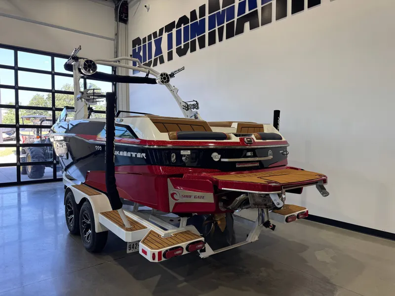 Slide: The Image of A red 2021 Malibu Wakesetter 23 LSV boat on a trailer inside a showroom. - 5