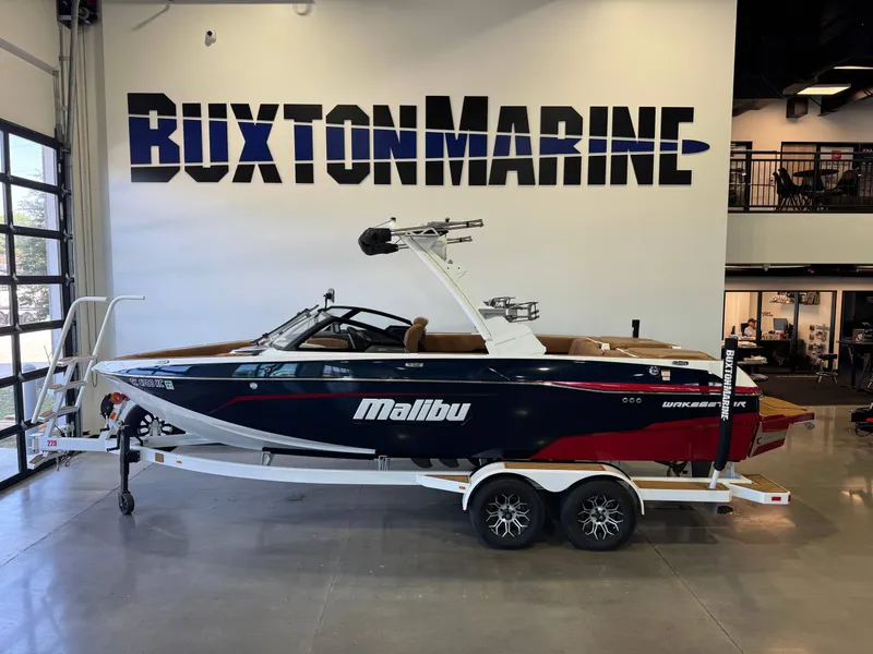 The Image of 2021 Malibu Wakesetter 23 LSV on a trailer in a showroom. - 1