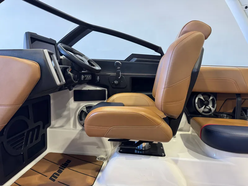 Slide: The Image of Interior of a 2021 Malibu Wakesetter 23 LSV with brown leather seats and a modern dashboard. - 22
