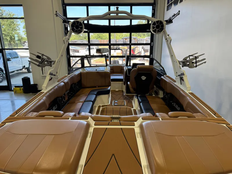 Slide: The Image of Interior of a 2021 Malibu Wakesetter 23 LSV with brown leather seats and speakers. - 8