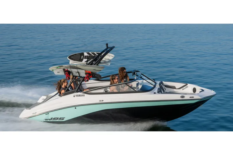 Slide: The Image of A 2026 Yamaha AR195 boat speeds across the water with two people on board. - 10