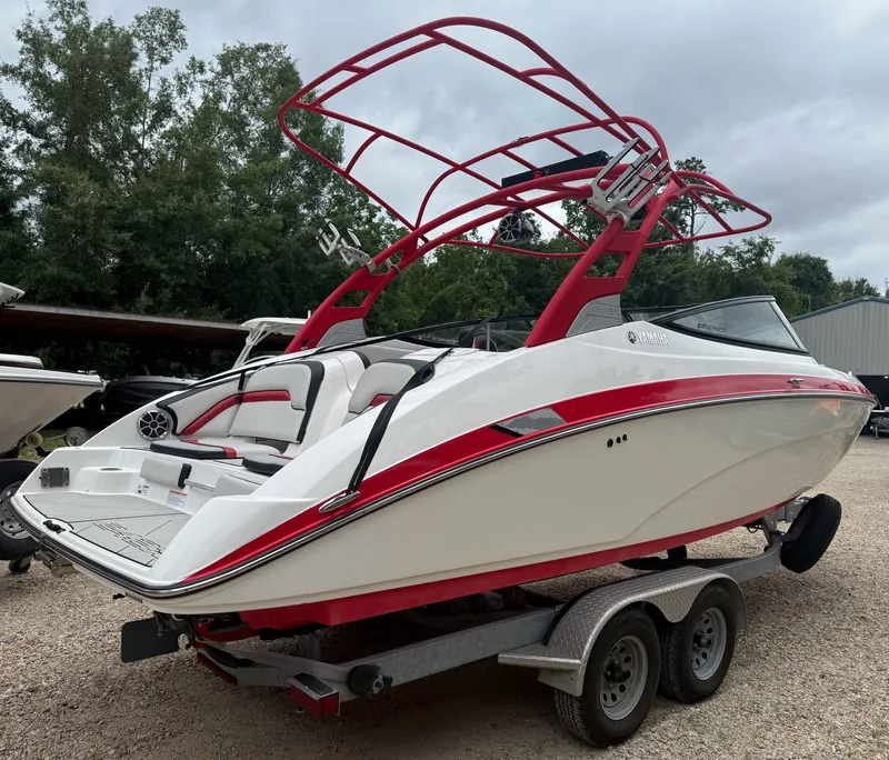 Slide: The Image of A 2020 Yamaha 242X boat on a trailer, featuring red accents and a tower. - 5