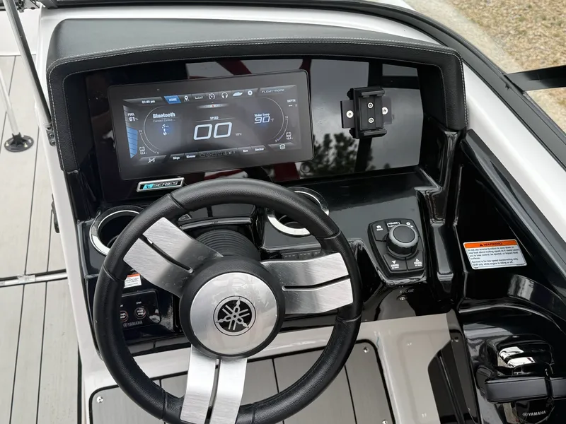 Slide: The Image of The image shows the helm of a 2020 Yamaha 242X boat with a modern display. - 11