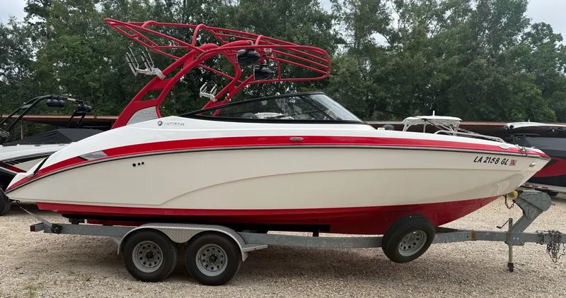 The Image of A 2020 Yamaha 242X boat on a trailer, featuring a red and white design. - 1