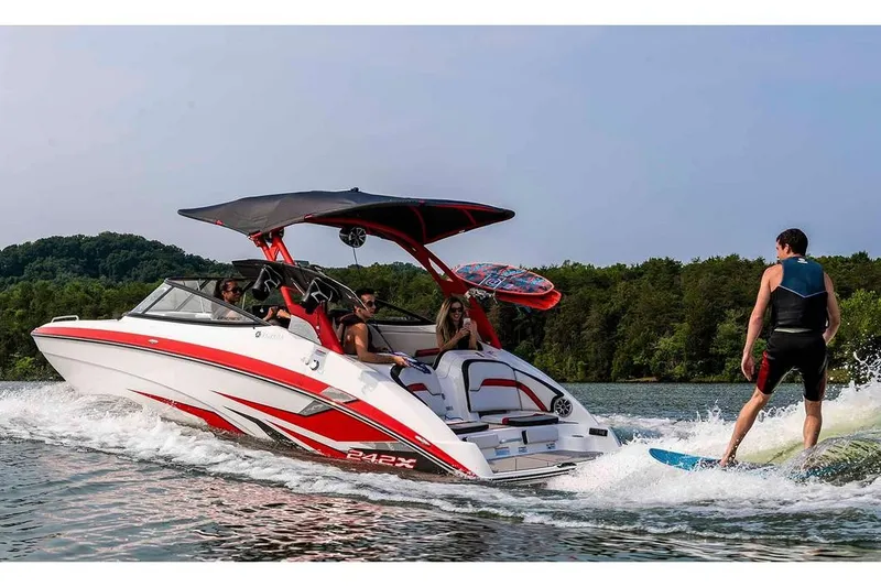 Slide: The Image of A 2020 Yamaha 242X boat towing a wakeboarder on a lake. - 18