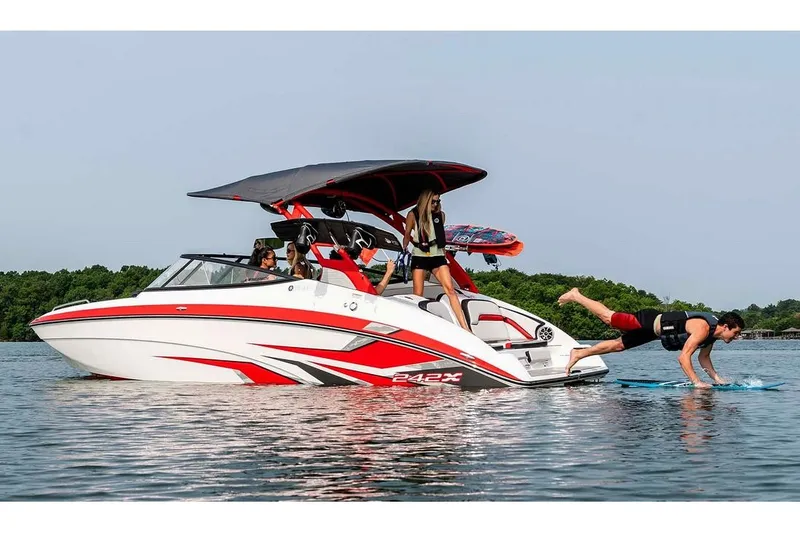 Slide: The Image of A 2020 Yamaha 242X boat on the water. People are enjoying water sports activities. - 19