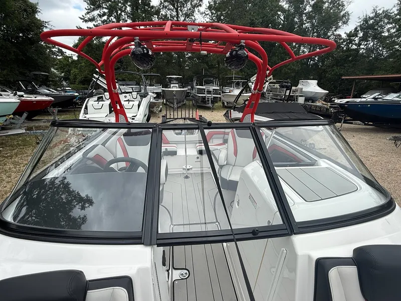 Slide: The Image of The image shows a 2020 Yamaha 242X boat with a red wakeboard tower and gray deck. - 10