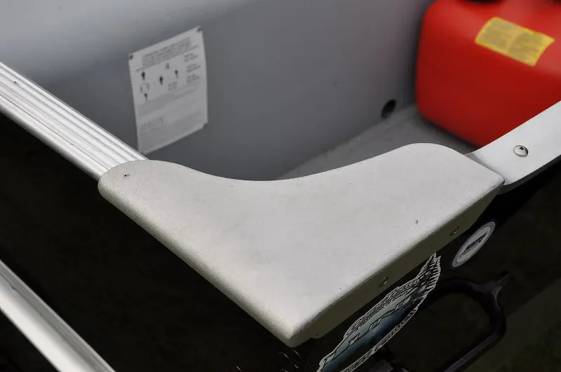 Slide: The Image of Manufacturer Provided Image: Close-up of a 2022 Lund A-12 boat interior with a red fuel tank. - 16