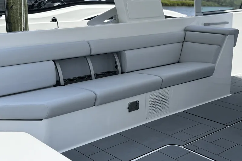 Slide: The Image of The 2024 Aviara AV40 OB features a sleek gray outdoor seating area with modern lines. - 17