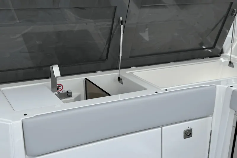 Slide: The Image of The 2024 Aviara AV40 OB features a sleek kitchenette with a sink and storage space. - 20