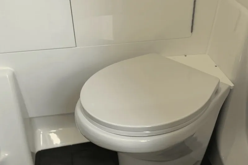 Slide: The Image of The image shows a modern, white toilet in a boat bathroom. - 37