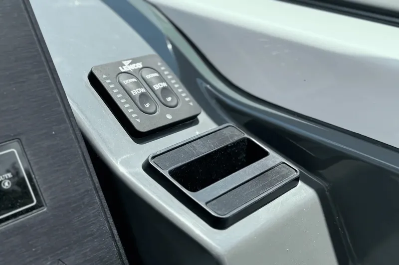Slide: The Image of Close-up of the control console with buttons and a storage compartment. - 28