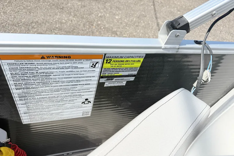 Slide: The Image of Warning labels and capacity information on a 2020 Godfrey Sweetwater 2286 C boat. - 7