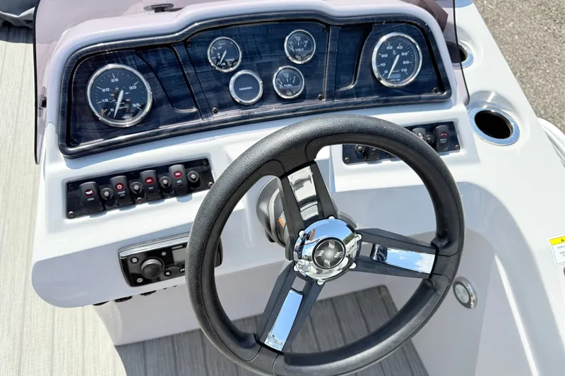 Slide: The Image of Steering console of 2020 Godfrey Sweetwater 2286 C boat with gauges and controls. - 6