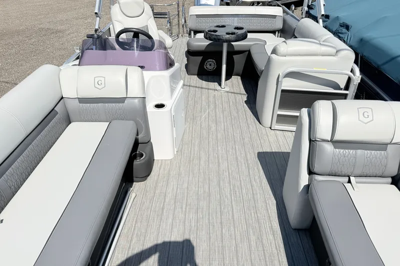 Slide: The Image of 2020 Godfrey Sweetwater 2286 C pontoon boat interior with plush seating and steering console. - 9