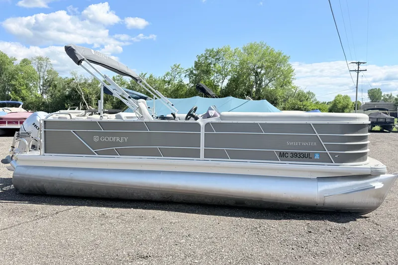 The Image of 2020 Godfrey Sweetwater 2286 C pontoon boat parked outdoors on a sunny day. - 0