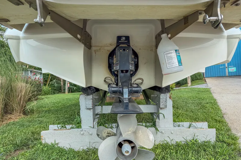 Slide: The Image of Rear view of a 2011 Cobalt 210 boat on a trailer, showing the propeller and outdrive. - 28