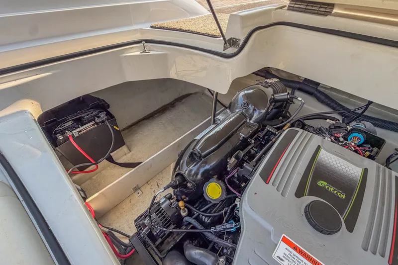 Slide: The Image of Engine compartment of a 2011 Cobalt 210 boat, featuring battery and engine components. - 26
