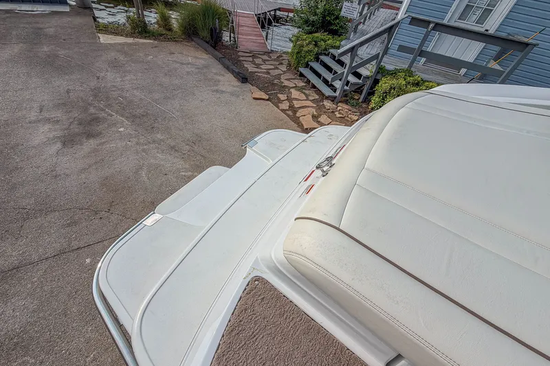 Slide: The Image of Rear view of a 2011 Cobalt 210 boat with white seating and swim platform. - 22