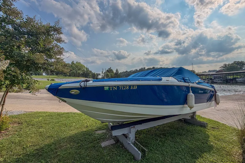 Slide: The Image of 2011 Cobalt 210 boat on trailer by lakeside under cloudy sky. - 6