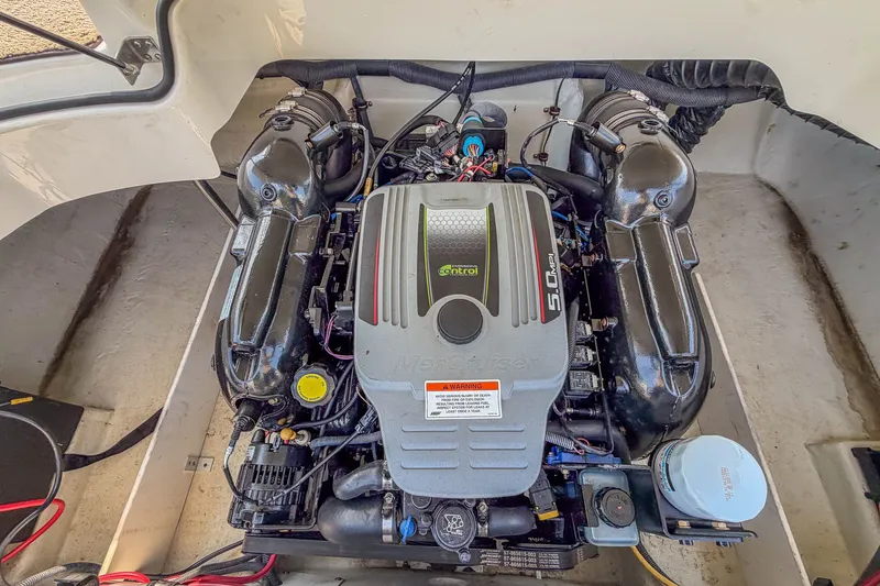 Slide: The Image of Engine compartment of a 2011 Cobalt 210 boat featuring a MerCruiser 5.0L engine. - 24