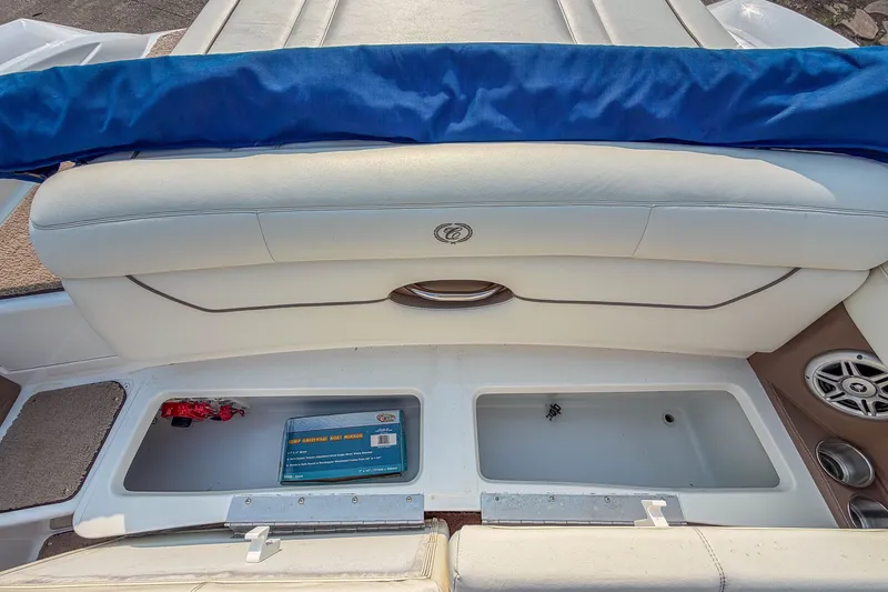 Slide: The Image of 2011 Cobalt 210 boat interior with storage compartments and cushioned seating. - 17