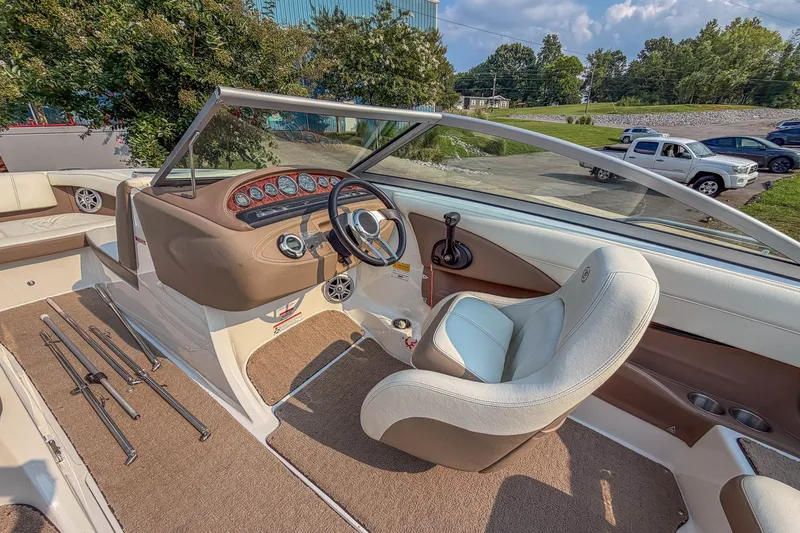 Slide: The Image of Interior of a 2011 Cobalt 210 boat with steering wheel and dashboard. - 13