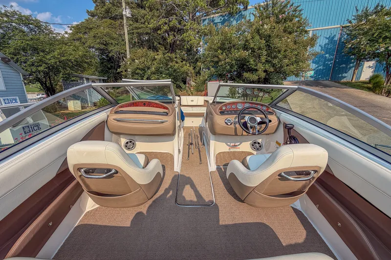 Slide: The Image of Interior view of a 2011 Cobalt 210 boat with beige seating and dashboard. - 11