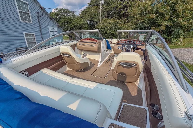 Slide: The Image of Interior of a 2011 Cobalt 210 boat with beige and white seating. - 21