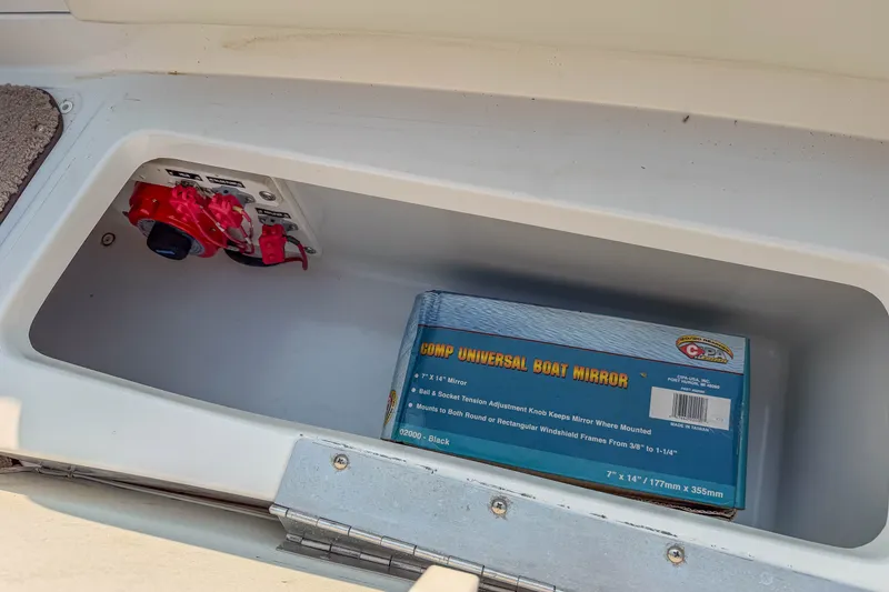 Slide: The Image of Storage compartment in a 2011 Cobalt 210 boat with a universal boat mirror box. - 16