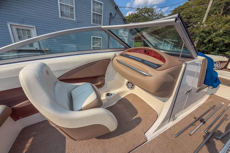 Slide: The Image of Interior of a 2011 Cobalt 210 boat with beige and white seating. - 12