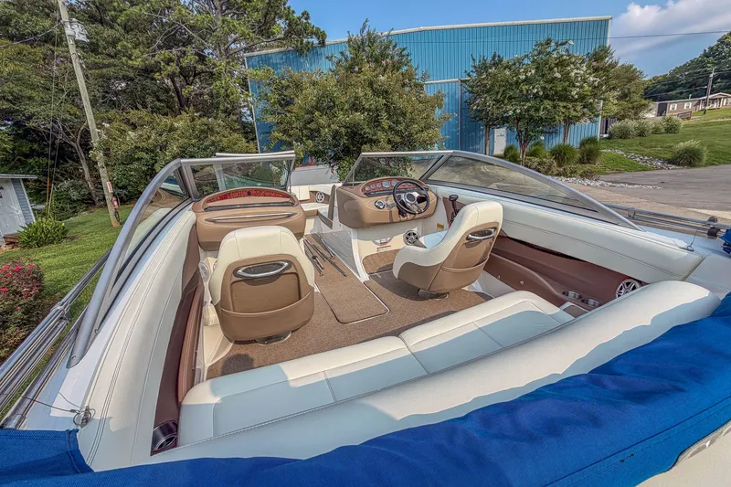 Slide: The Image of Interior view of a 2011 Cobalt 210 boat with beige and white seating. - 19