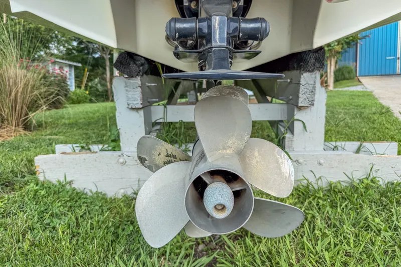 Slide: The Image of Rear view of a 2011 Cobalt 210 boat propeller on a grassy area. - 27