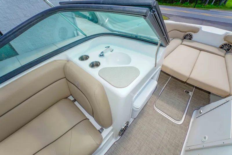 Slide: The Image of Interior of 2020 NauticStar 203 DC boat with beige seating and built-in cup holders. - 18