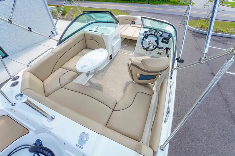 Slide: The Image of 2020 NauticStar 203 DC boat interior with beige seating and steering console. - 12